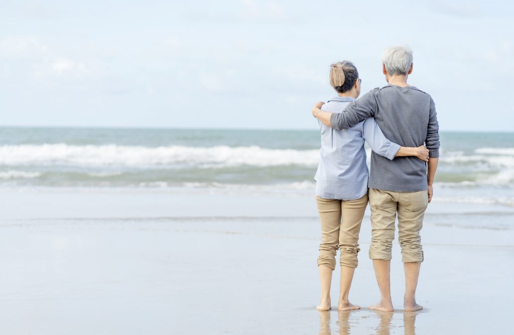 asian couple senior walking beach holding hands honeymoon family together happiness lifestyle life after retirement plan life insurance 1