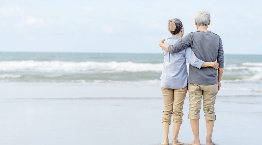 asian couple senior walking beach holding hands honeymoon family together happiness lifestyle life after retirement plan life insurance 1